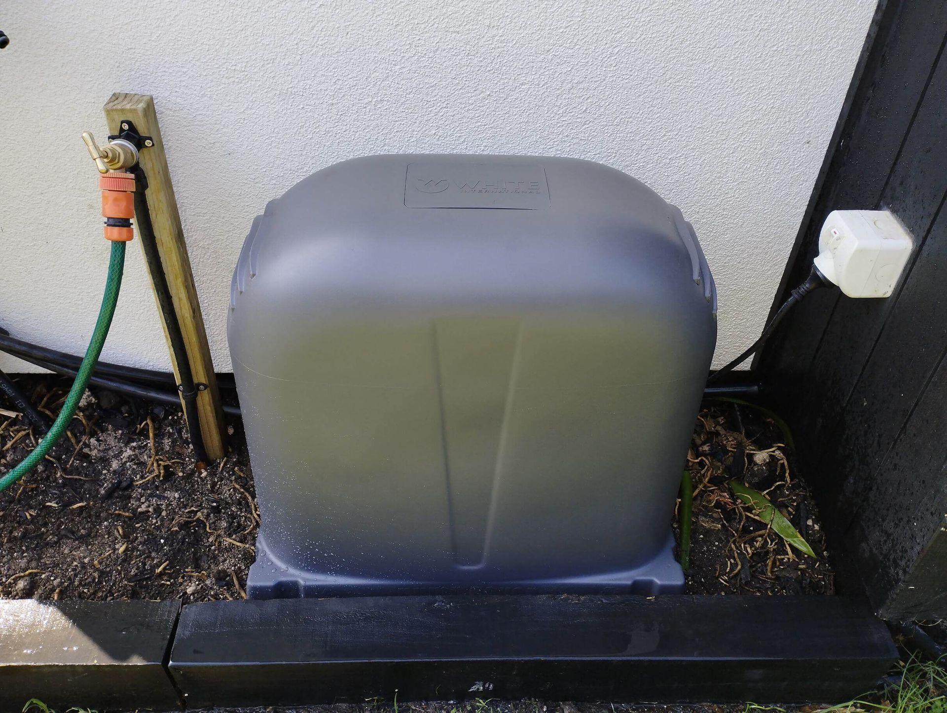 Charcoal grey pump cover and tap installed in The Mount, BOP, NZ. Ready for a garden hose to be hooked up