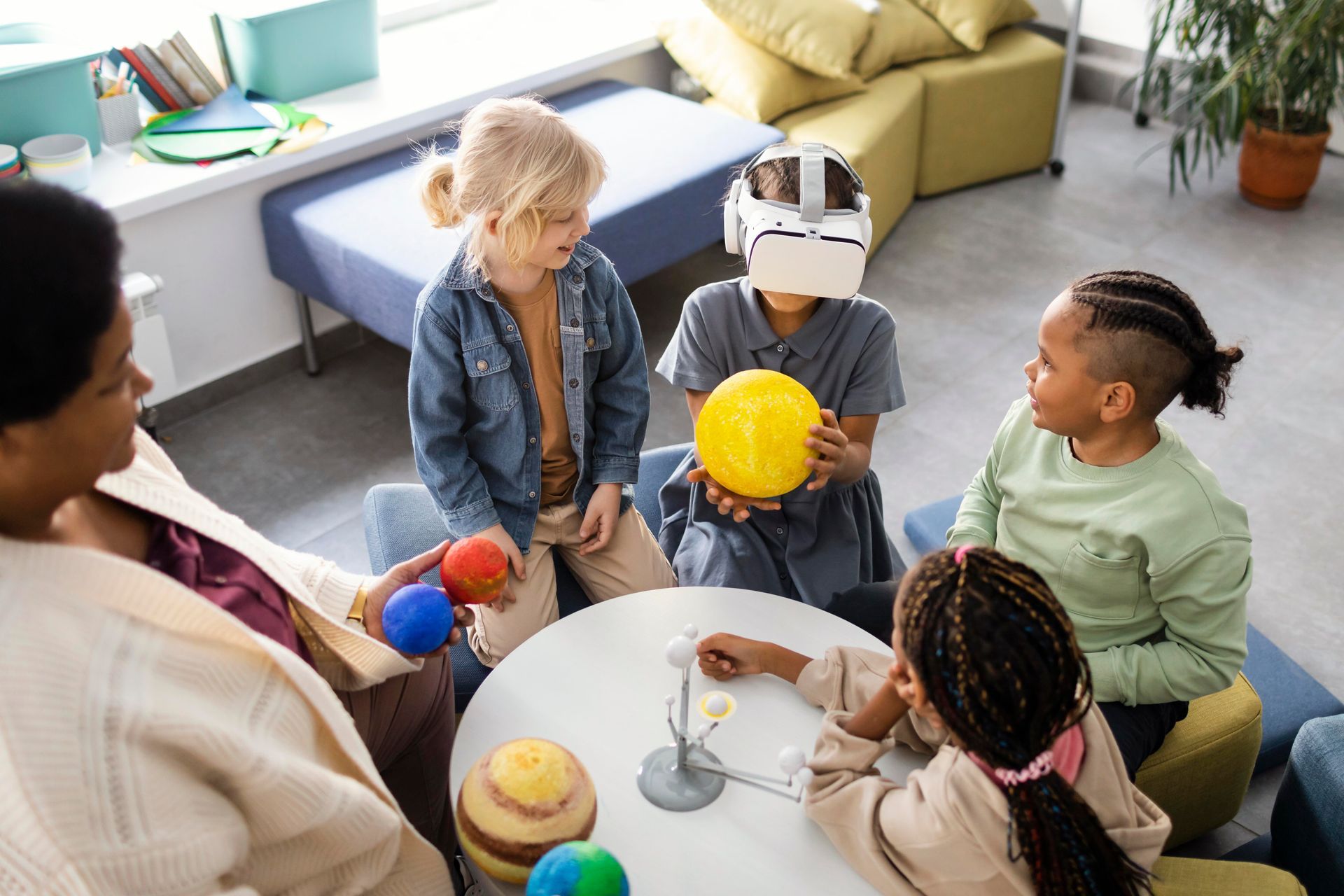 A group of children are sitting around a table playing a game.