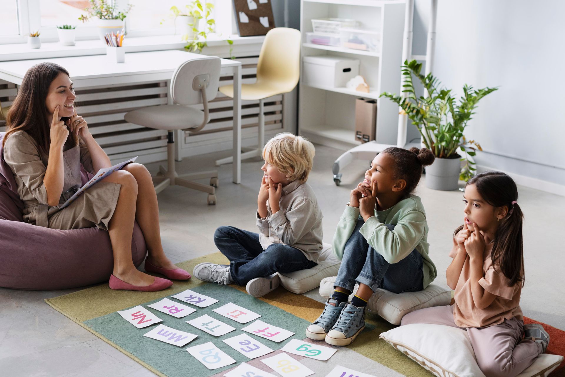 A woman is sitting on a bean bag chair talking to a group of children.