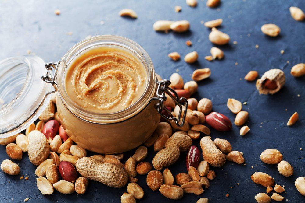 Peanut Butter Jar and Heap of Nuts — Grocery Store in Mid North Coast, NSW