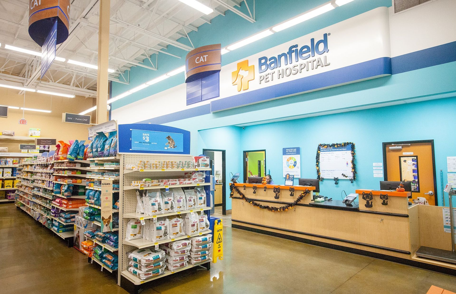 Pharmacy checkout area with shelves, self-service kiosks, and a Bluefield Free Hospital sign