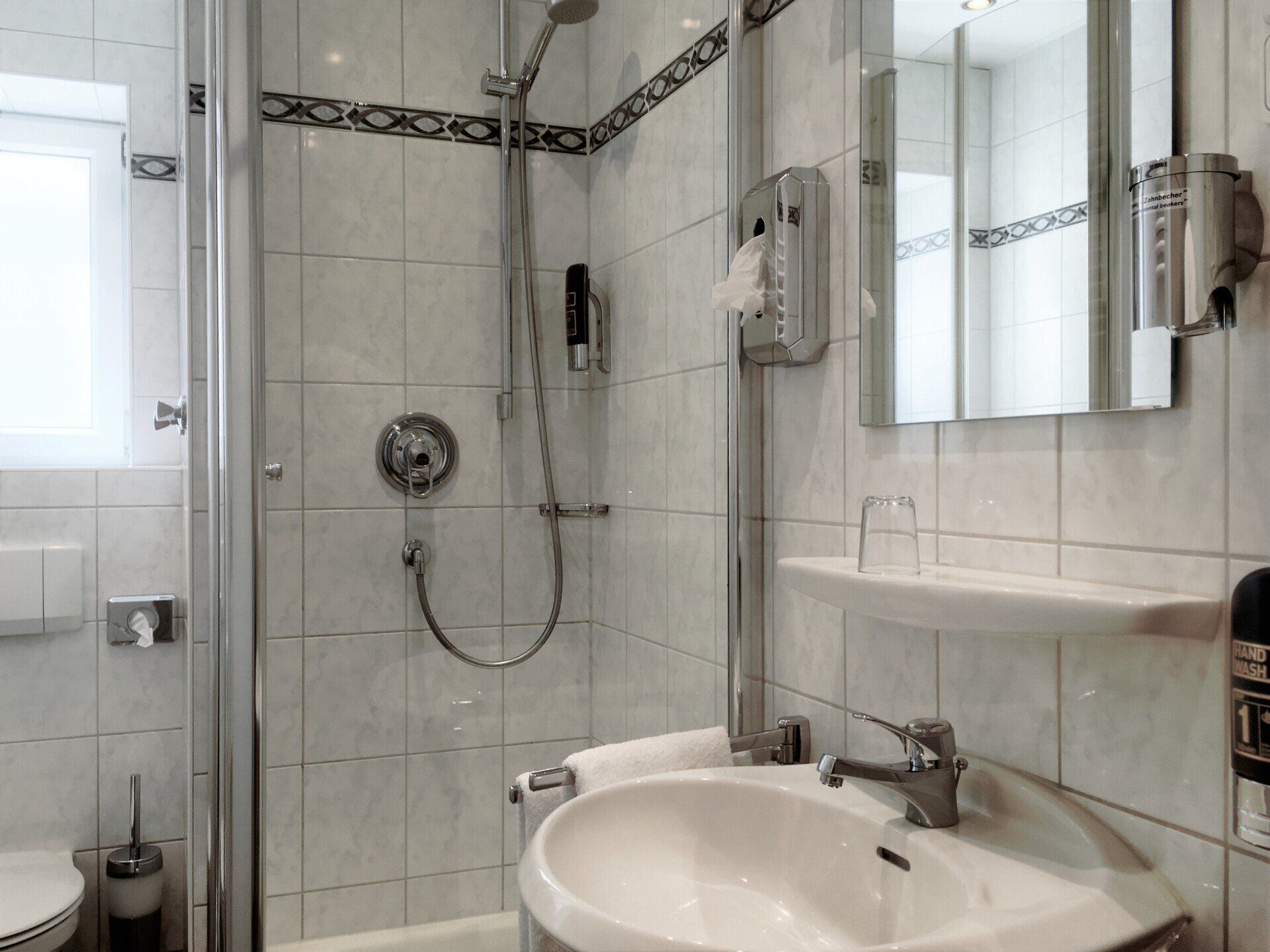 Ein Badezimmer mit Waschbecken, Toilette und Dusche