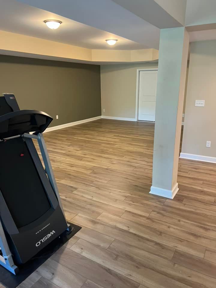 there is a treadmill in the middle of the room .