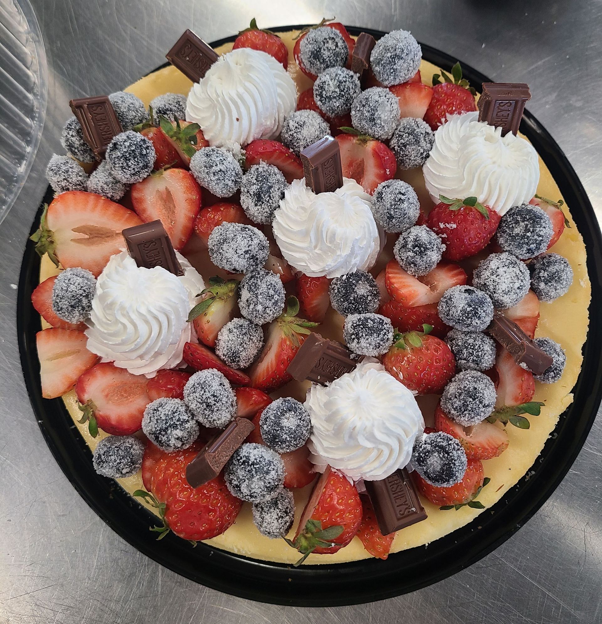 A cheesecake with strawberries and whipped cream on top