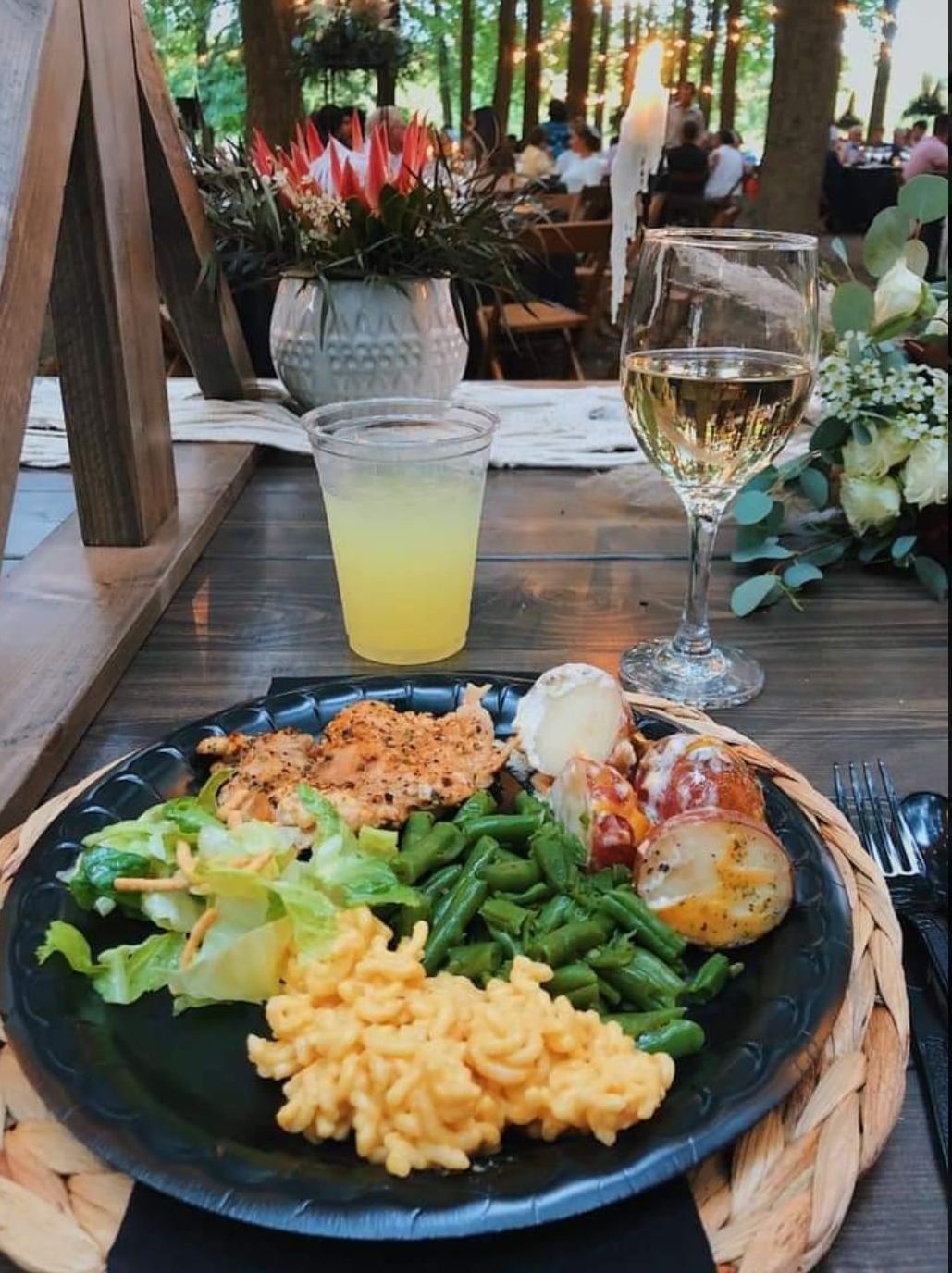 A plate of food and a glass of wine on a table.