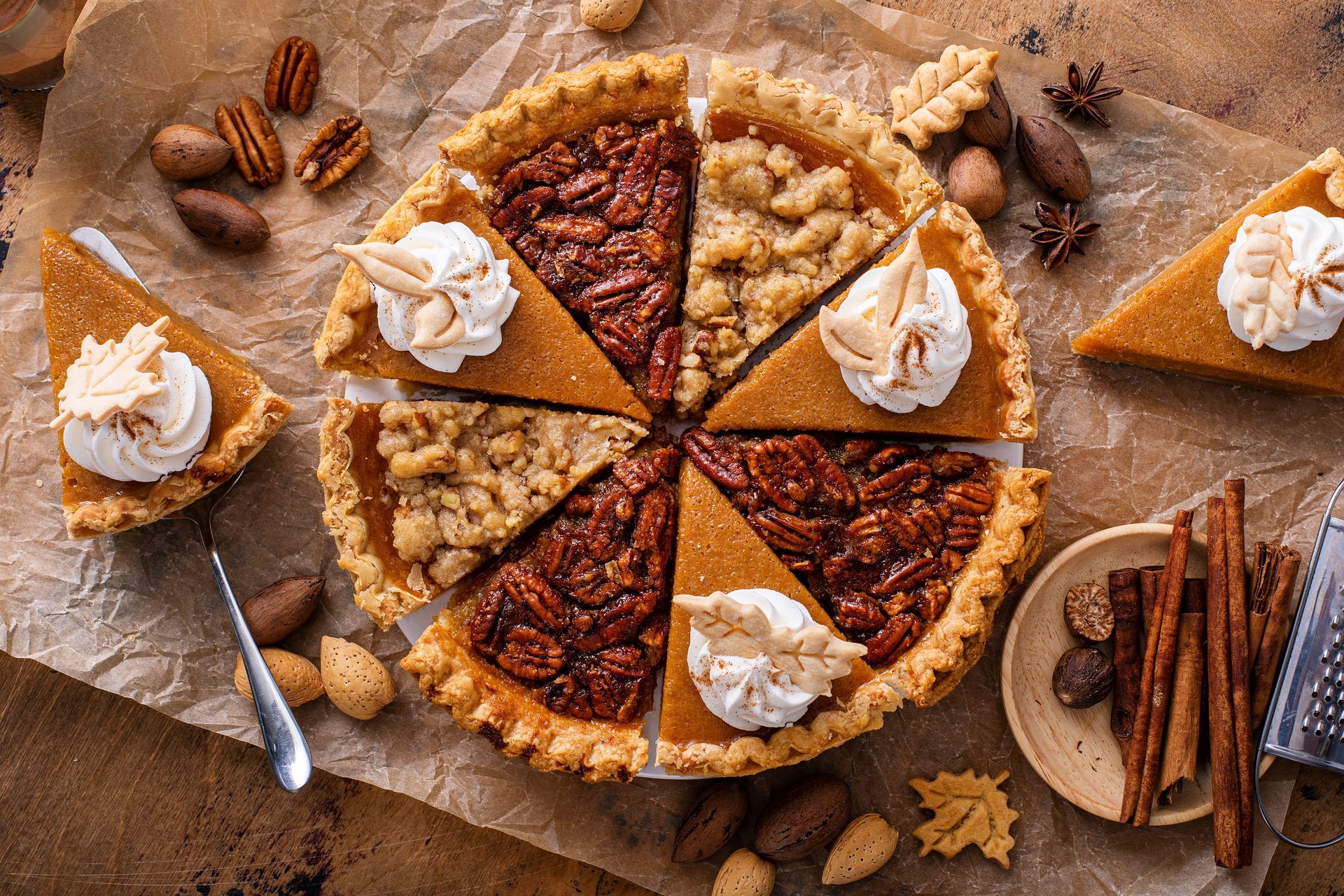 There are many different types of pies on the table.