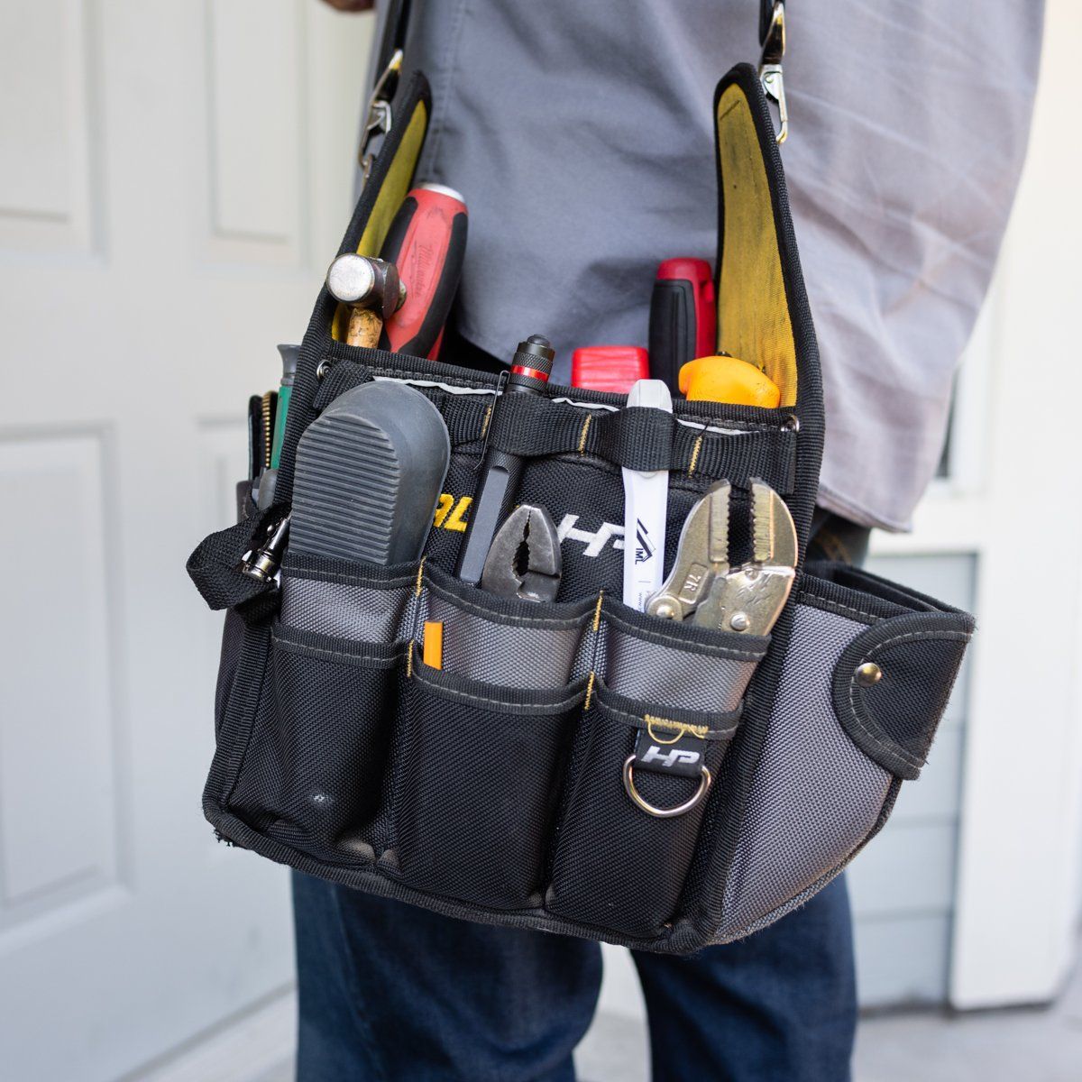 a man is carrying a tool bag