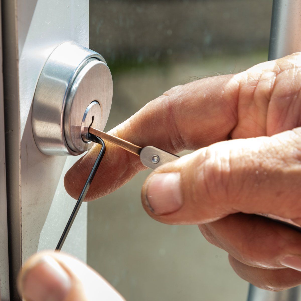 a person is using a wrench to open a door lock