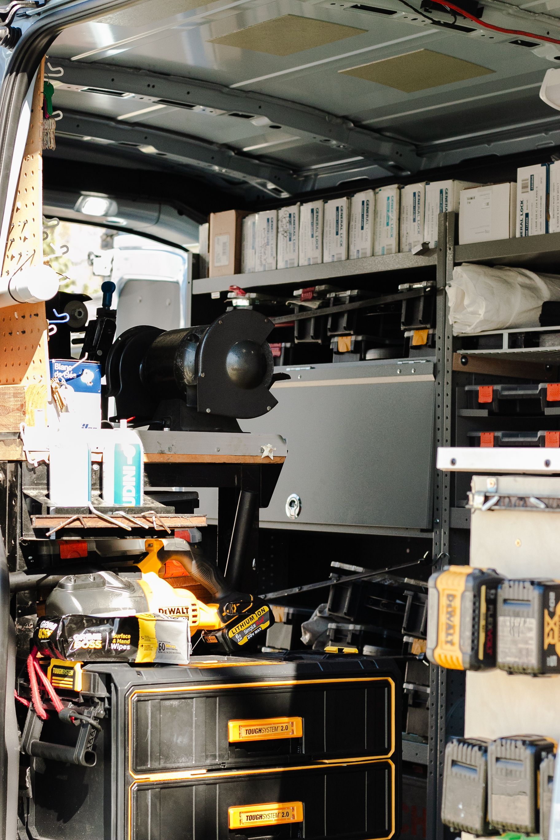 The inside of a van filled with tools including a dewalt drill