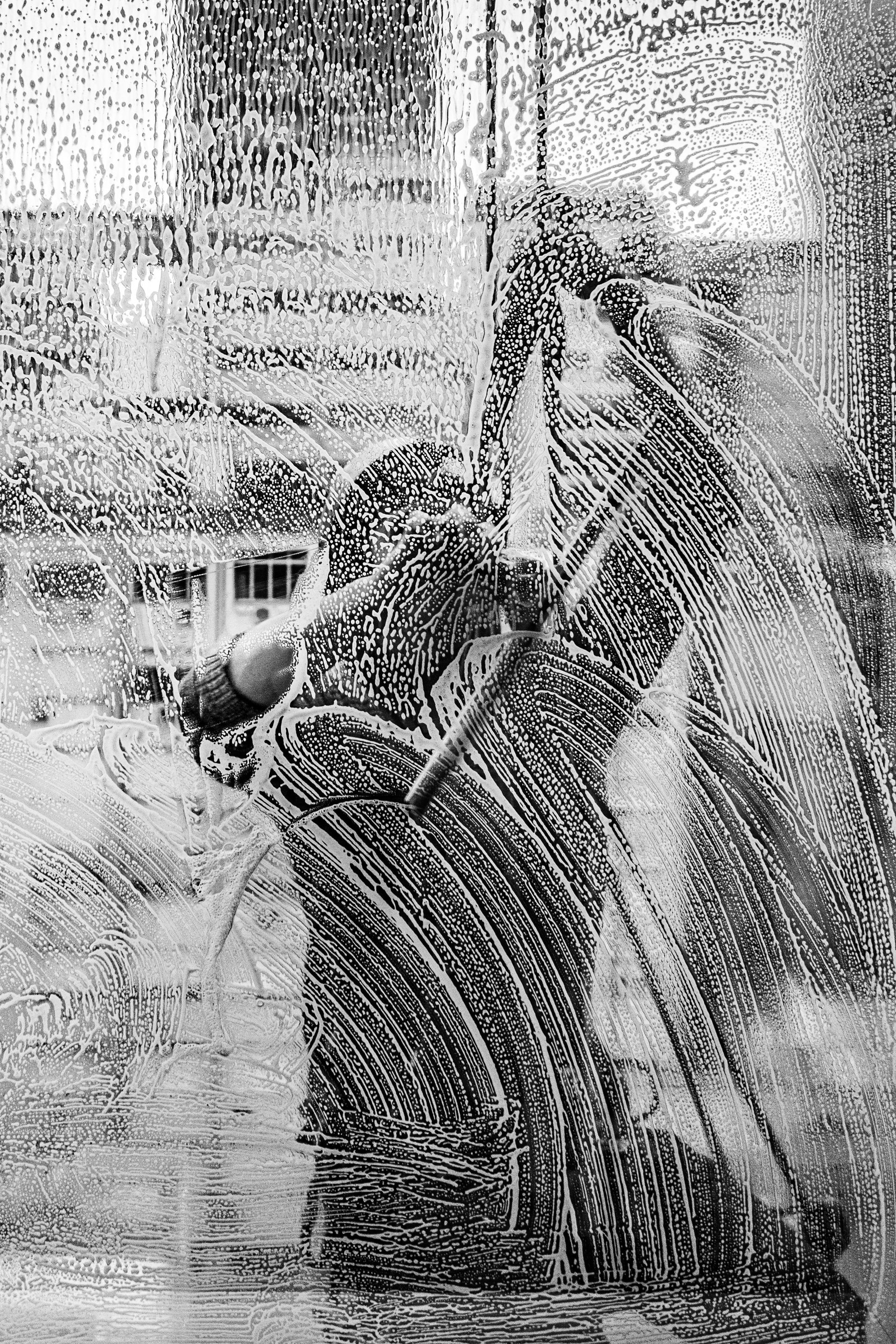 A black and white photo of a woman in a long dress.
