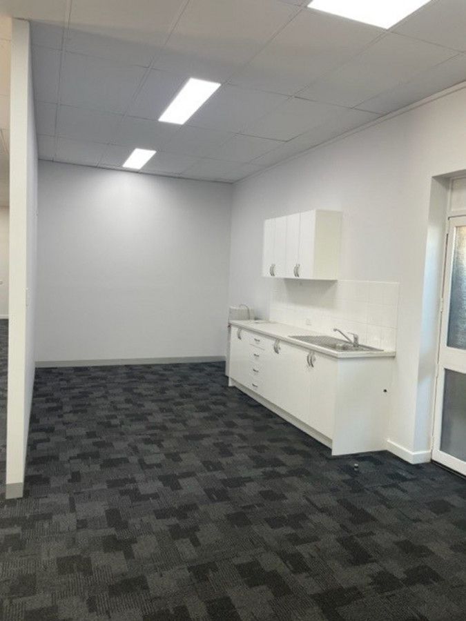 There is a kitchen in the middle of the room.