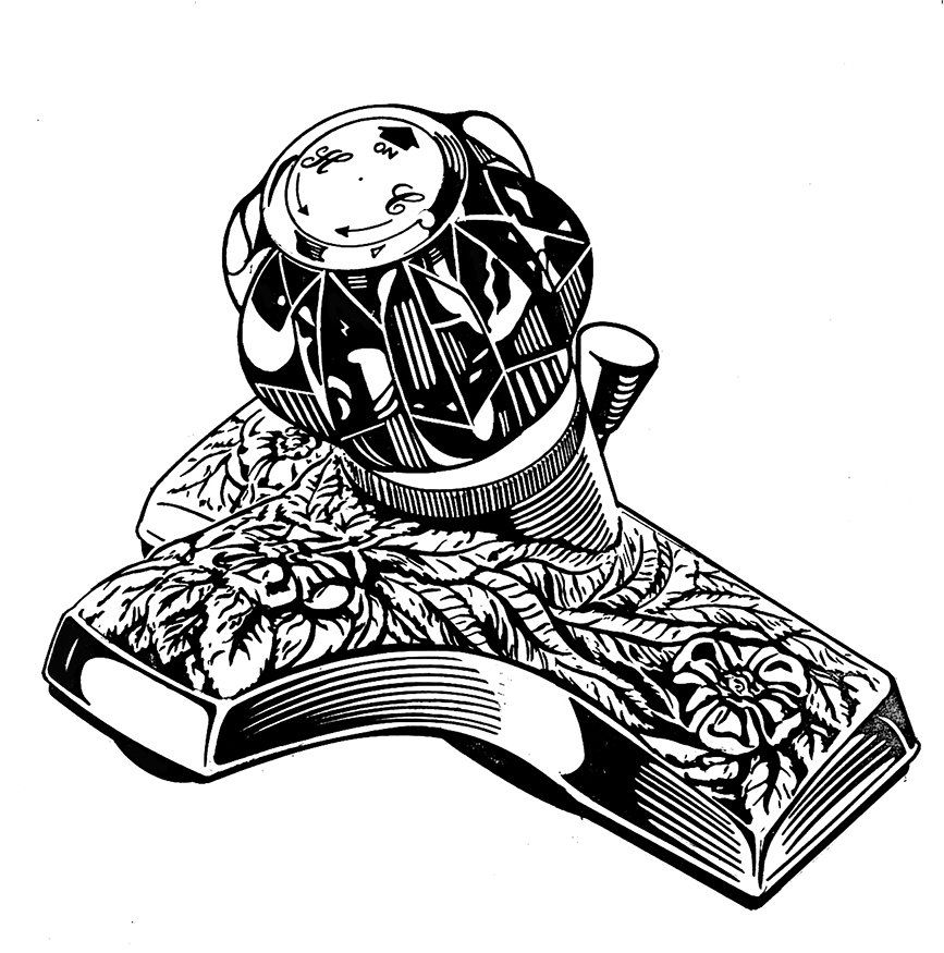 Inkwell with ornate floral design.