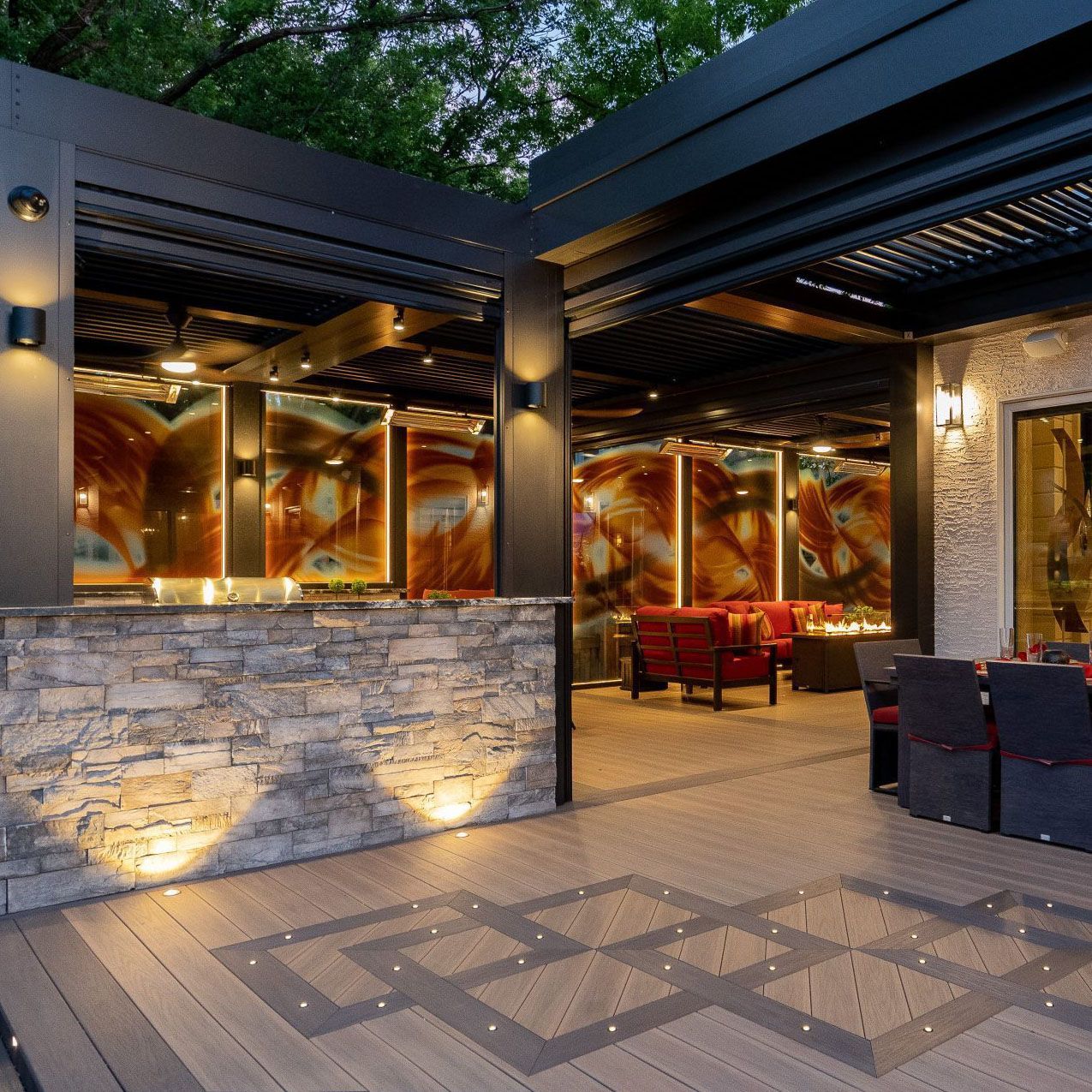 Outdoor patio with stone bar, seating area, and decorative lighting.