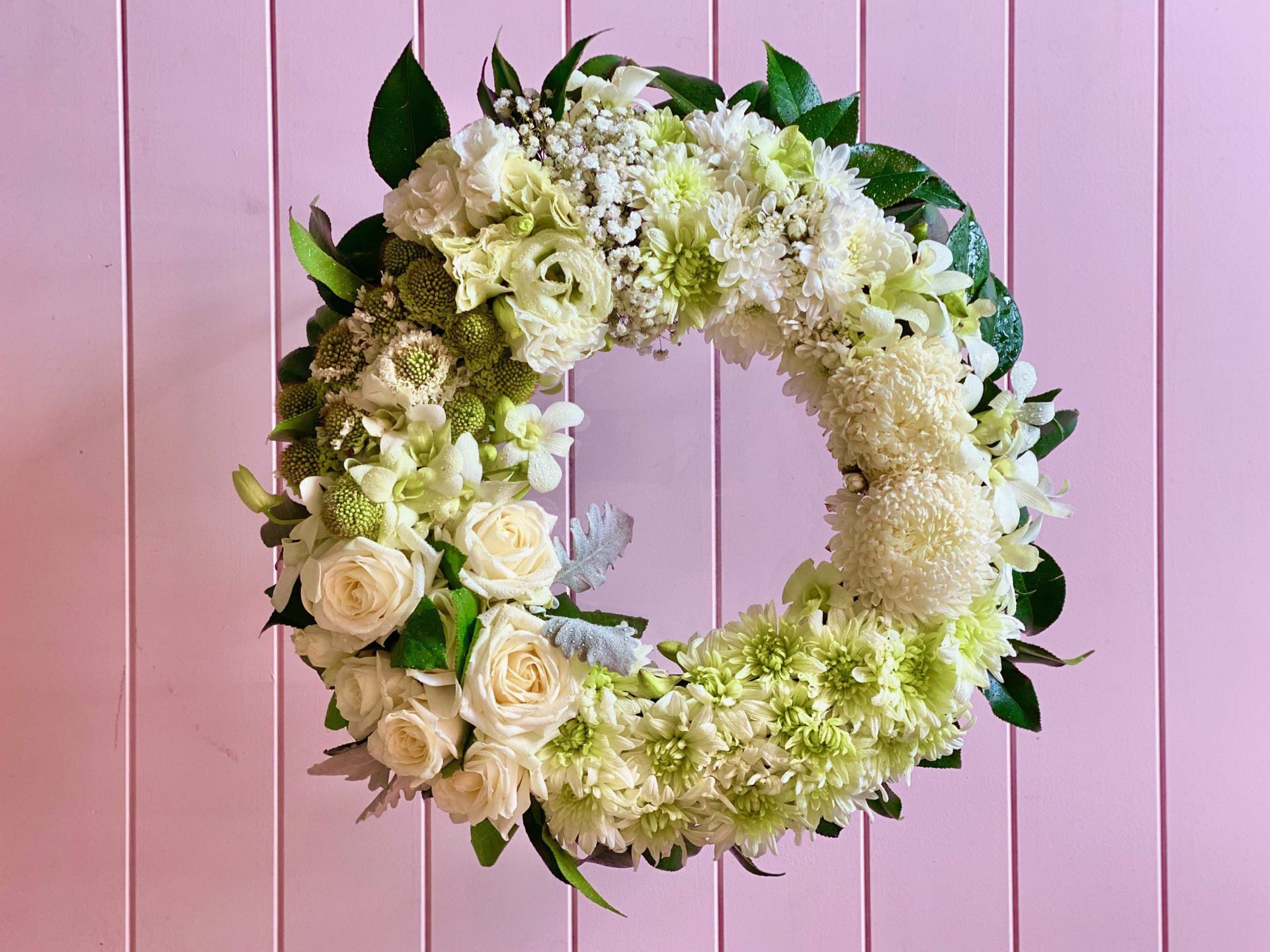 Elegant white wreath, a timeless creation by Darwin's florist.