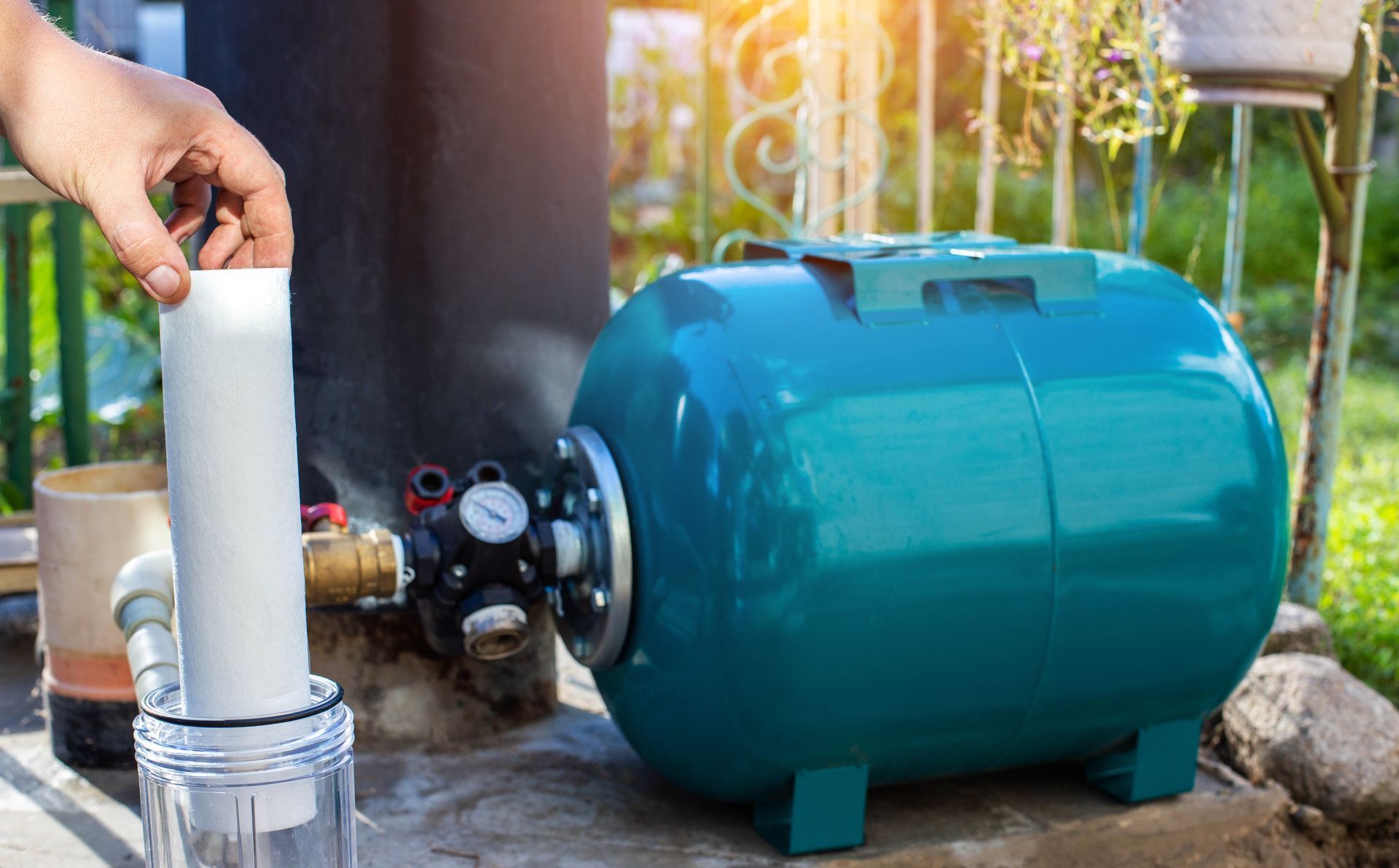 A person is putting a filter into a water tank.