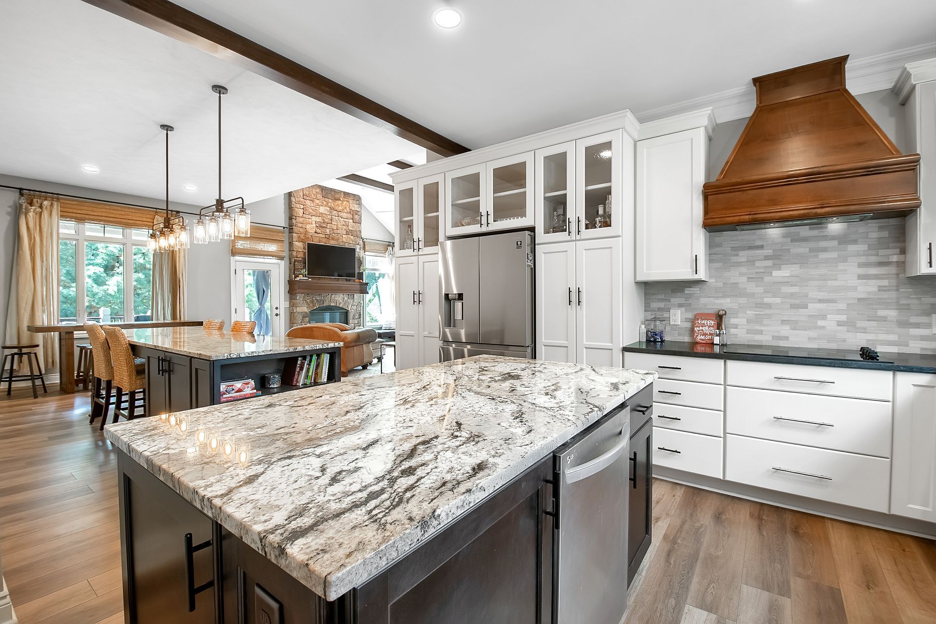 A kitchen with granite counter tops and stainless steel appliances.