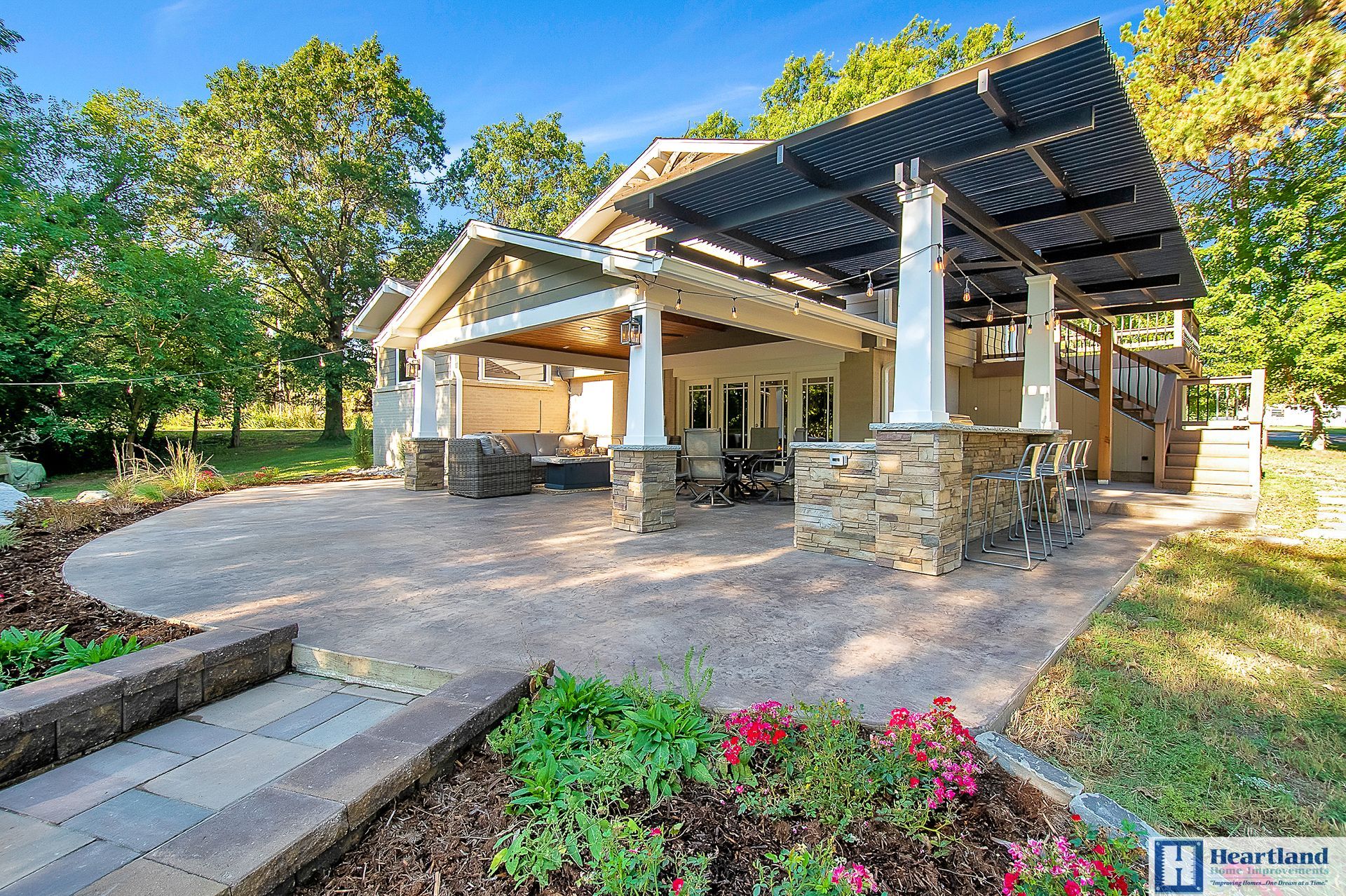 A house with a pergola and a patio in front of it