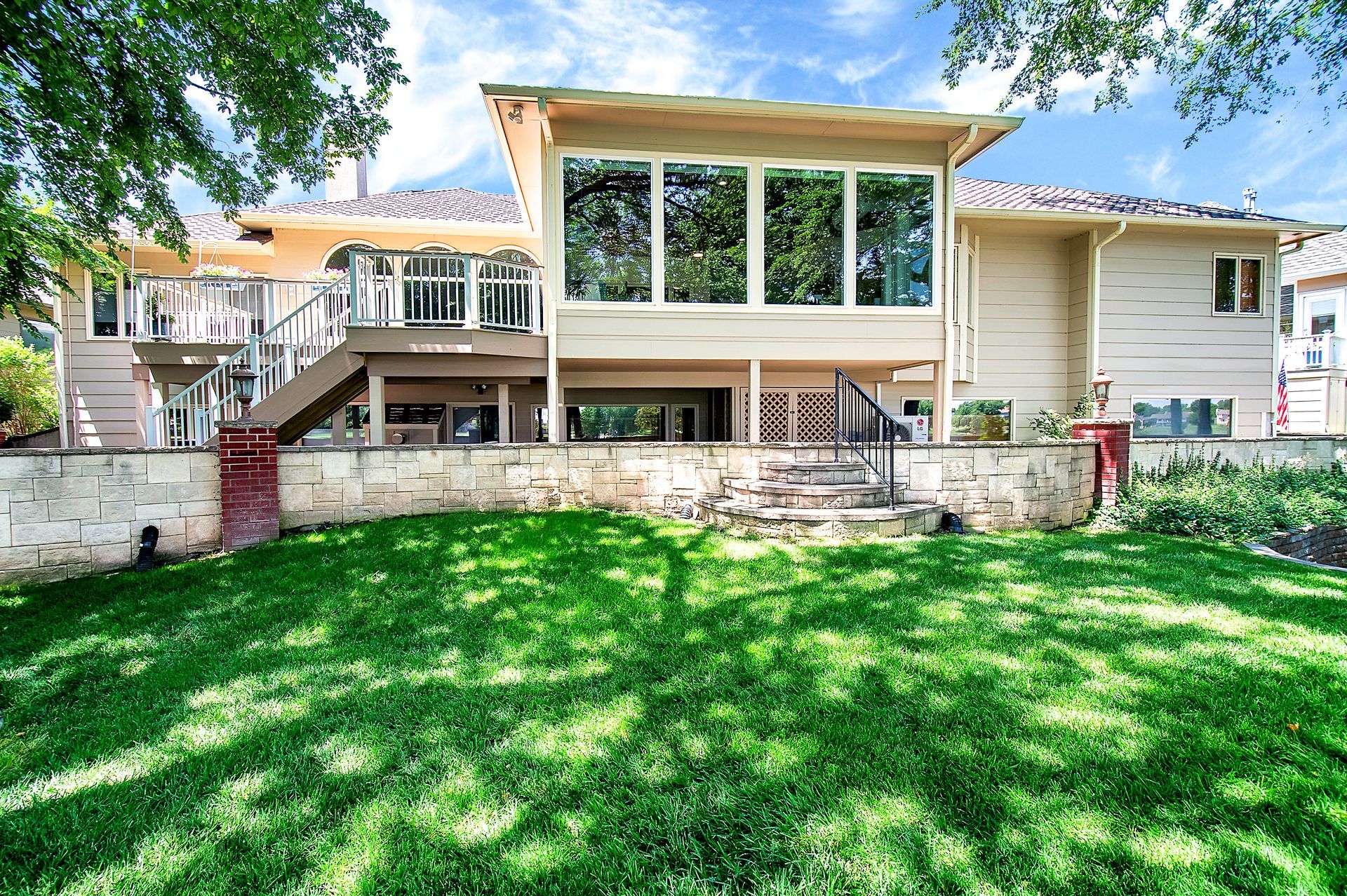 A large house with a large lawn in front of it.