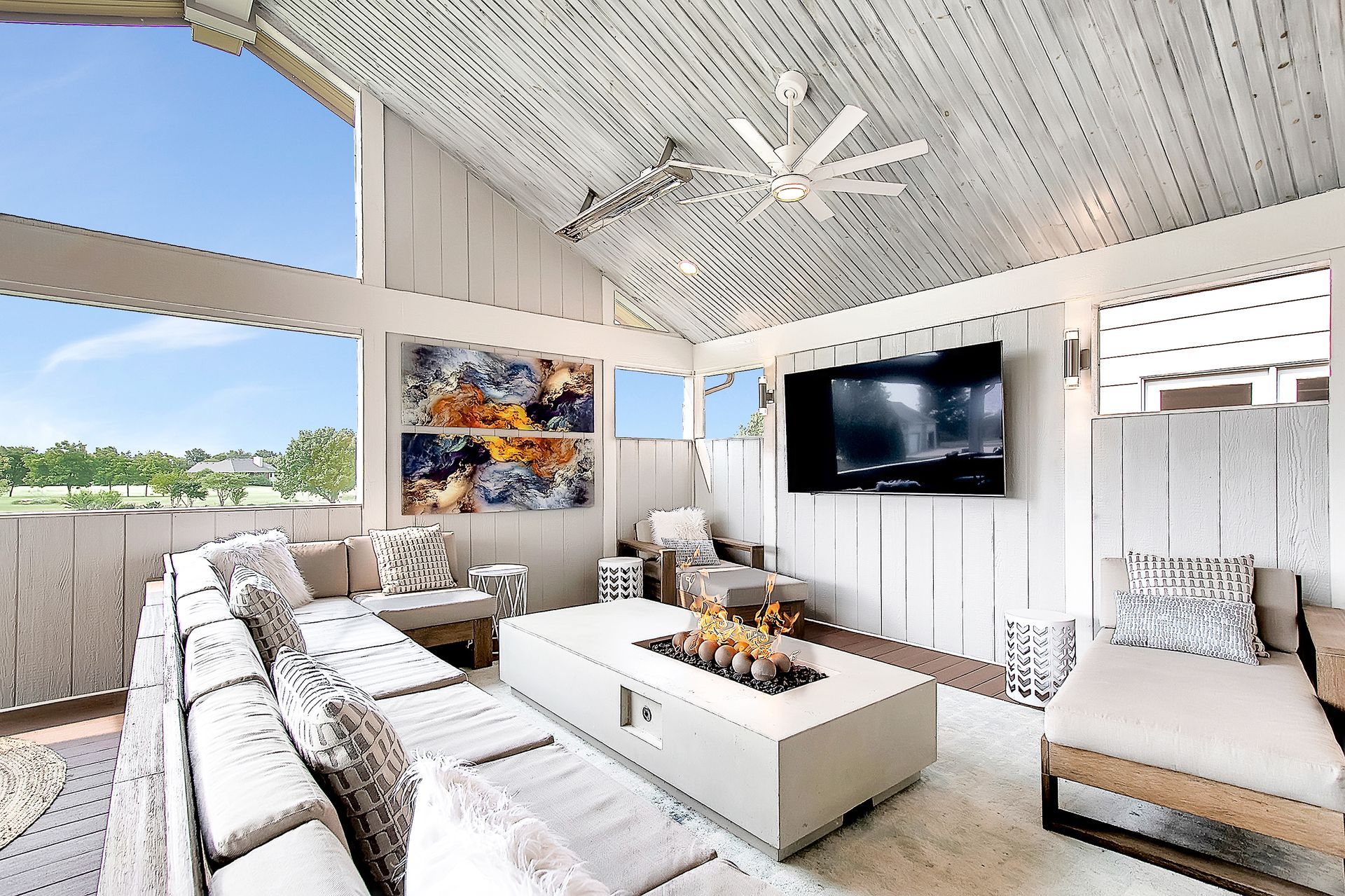 A living room with a fire pit and a flat screen tv