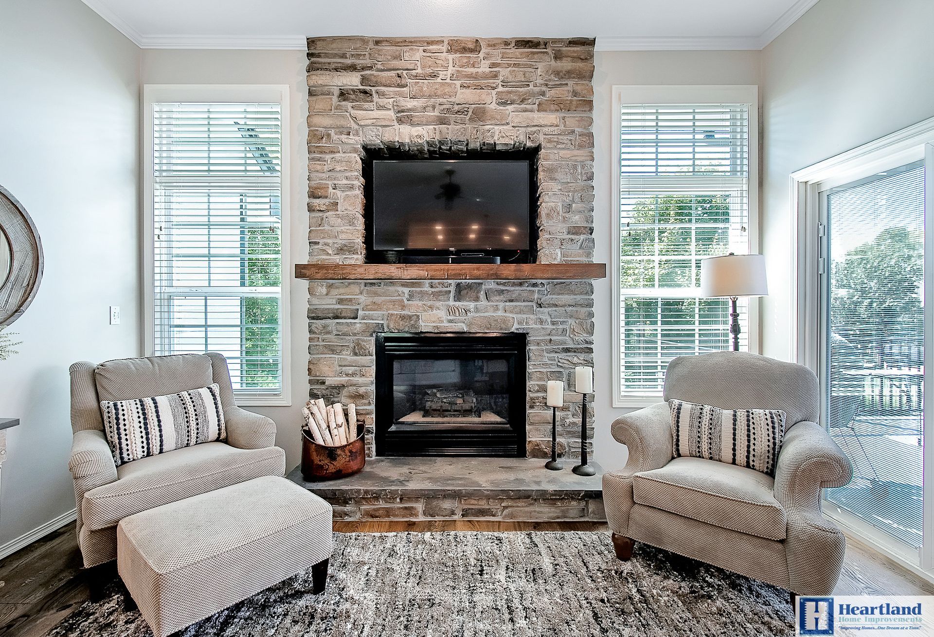 A living room with a fireplace and a flat screen tv