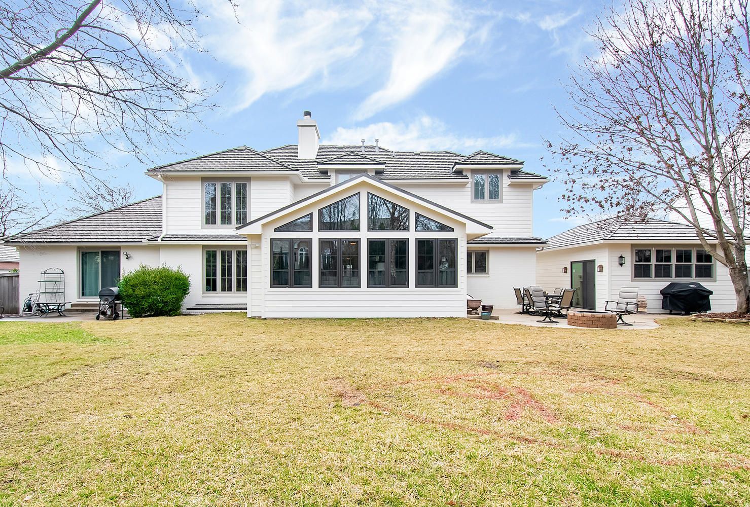 A large white house with a large screened in porch