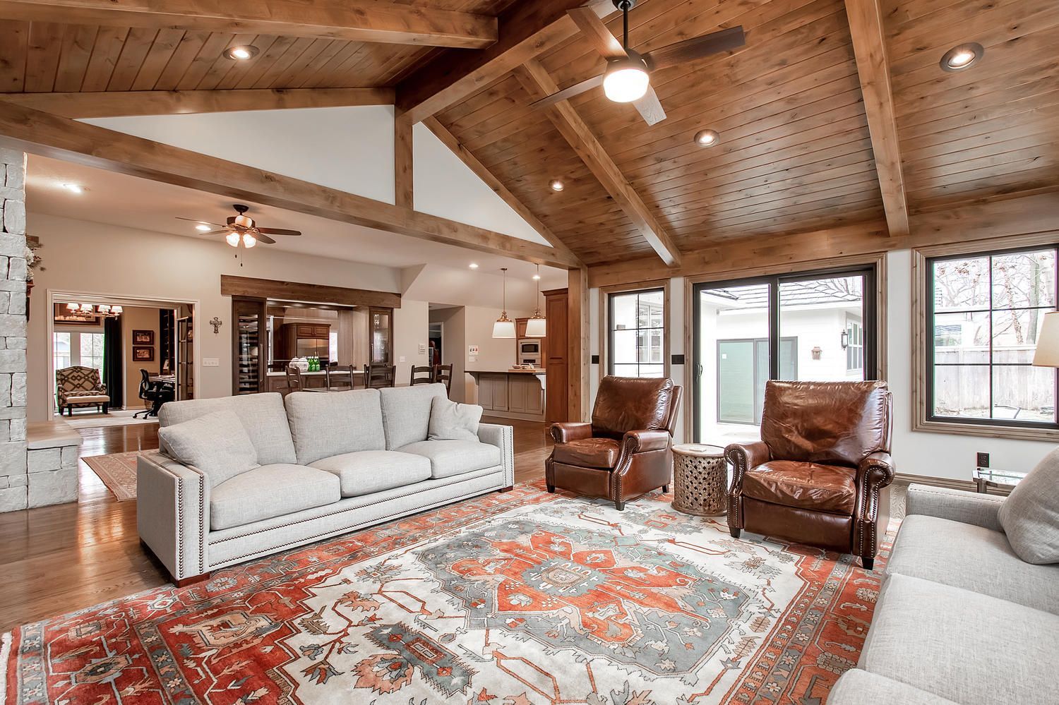 A living room with a couch , chairs , and a rug.