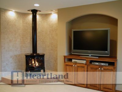 A living room with a fireplace and a flat screen tv