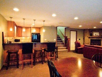 A living room with a table and chairs and a kitchen