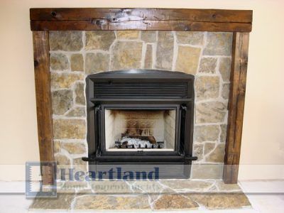 A fireplace with a heartland logo on it