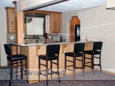 A kitchen with a bar and stools and the word eastland on the bottom