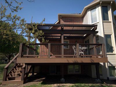 The back of a house with a large deck and stairs