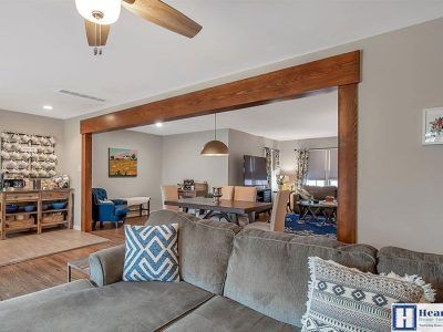 A living room with a couch and a ceiling fan.