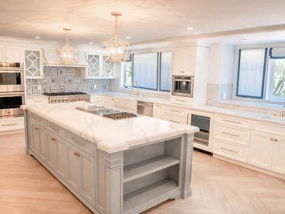 A large kitchen with a large island in the middle.