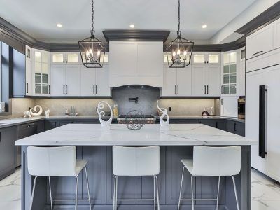 A kitchen with a large island and stools.