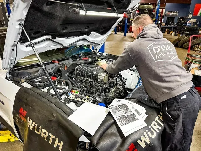 Technician Servicing Vehicle Engine In Auto Repair Shop | DTM Autowerks