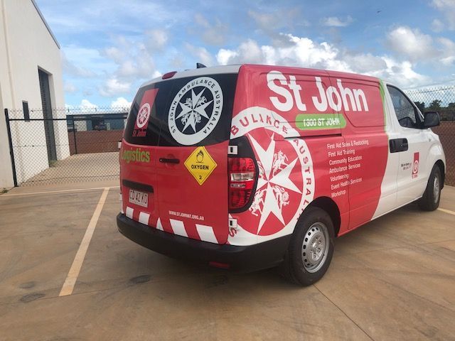 A Green Jurassic Park Car Is Parked In A Garage — Northern Territory Sign Services in Winnellie, NT