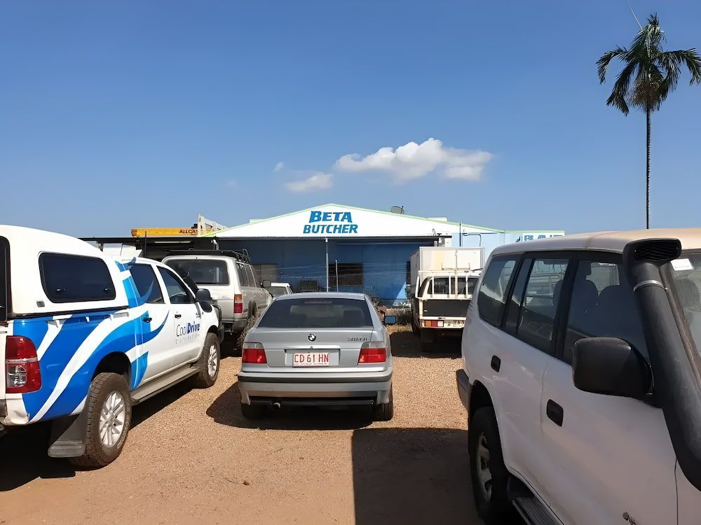 Several Cars Are Parked In Front Of A Building — Northern Territory Sign Services in Winnellie, NT