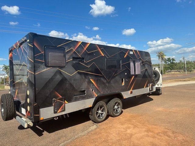 A Boat Is Parked On The Side Of The Road On A Trailer — Northern Territory Sign Services in Winnellie, NT