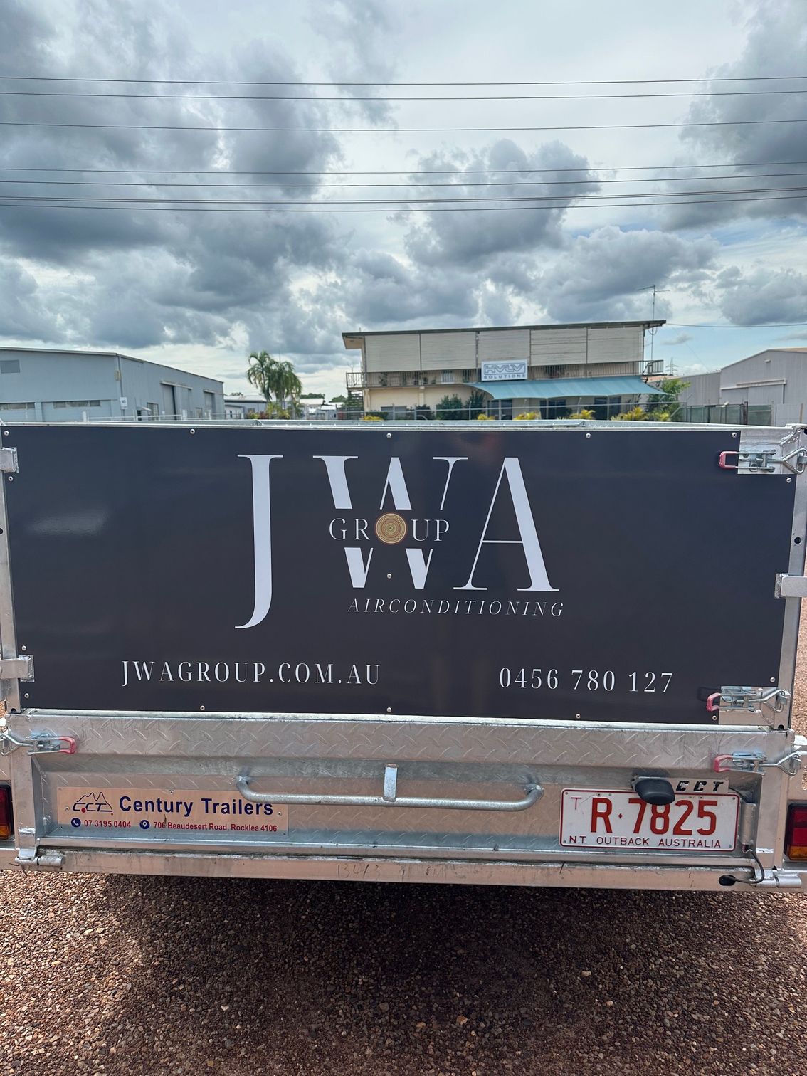 A Boat Is Being Towed By A Truck On A Trailer — Northern Territory Sign Services in Winnellie, NT