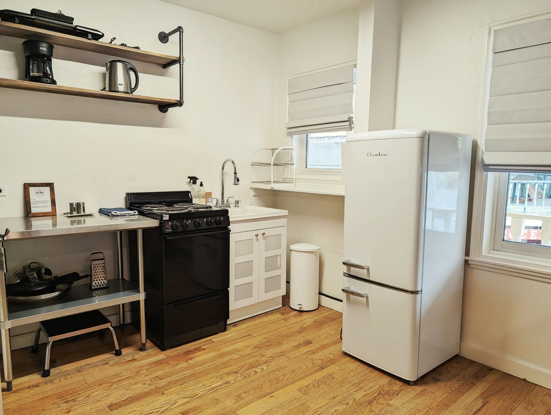 A kitchen with a white refrigerator and a black stove