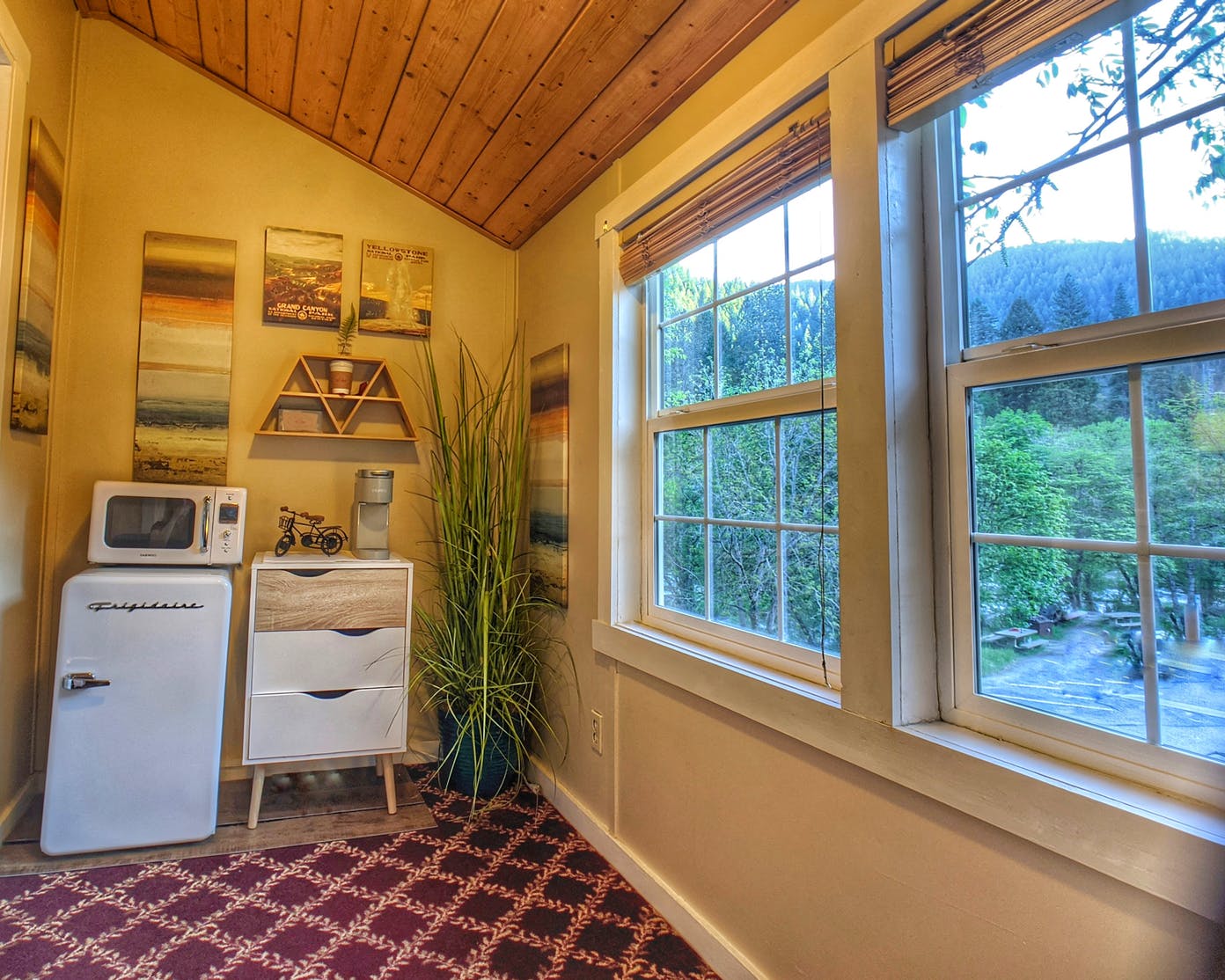 A room with a lot of windows and a microwave.