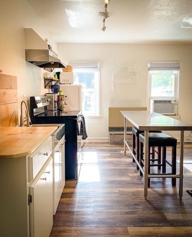 A kitchen with a table and stools in it