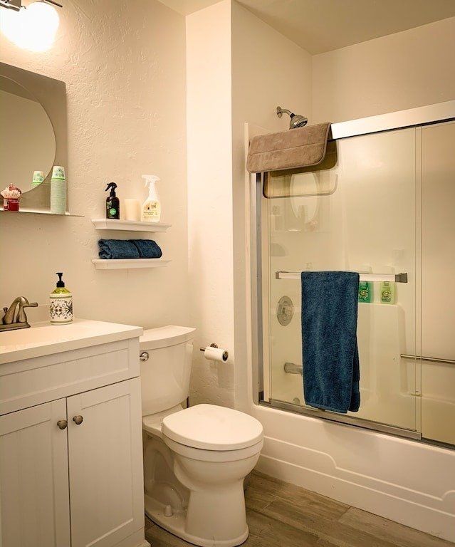 A bathroom with a toilet , sink and shower.