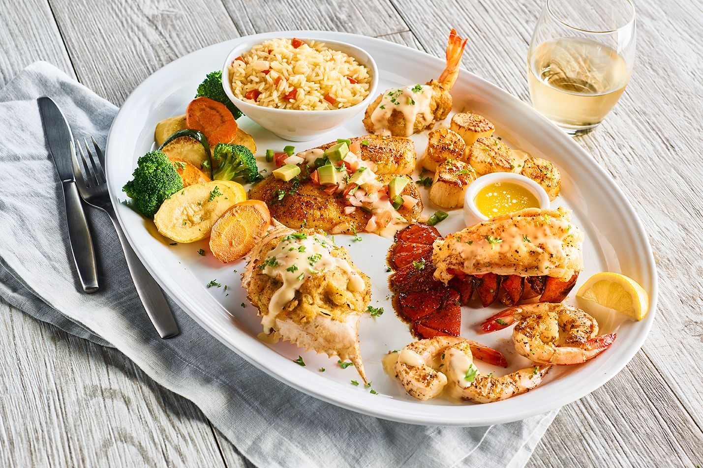 A white plate topped with a variety of seafood and vegetables