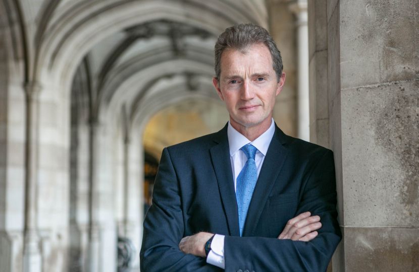 Image of the Rt Hon David TC Davies leaning against a wall at the Palace of Westminster