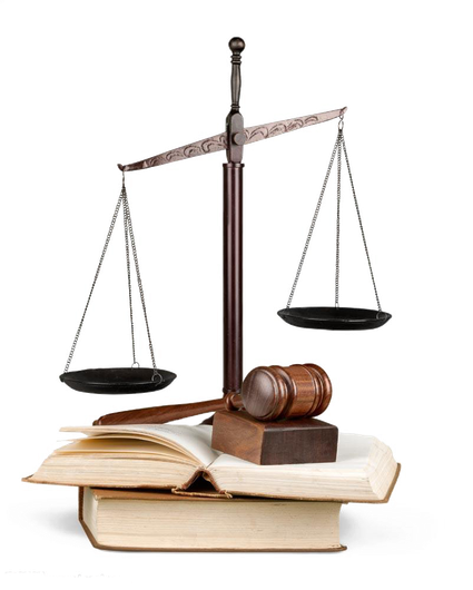 A scale of justice is sitting on top of a stack of books.