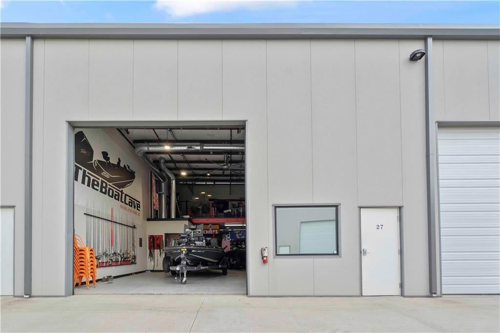 Exterior of an occupied garage suite at The Lux with the overhead door open to a finished interior
