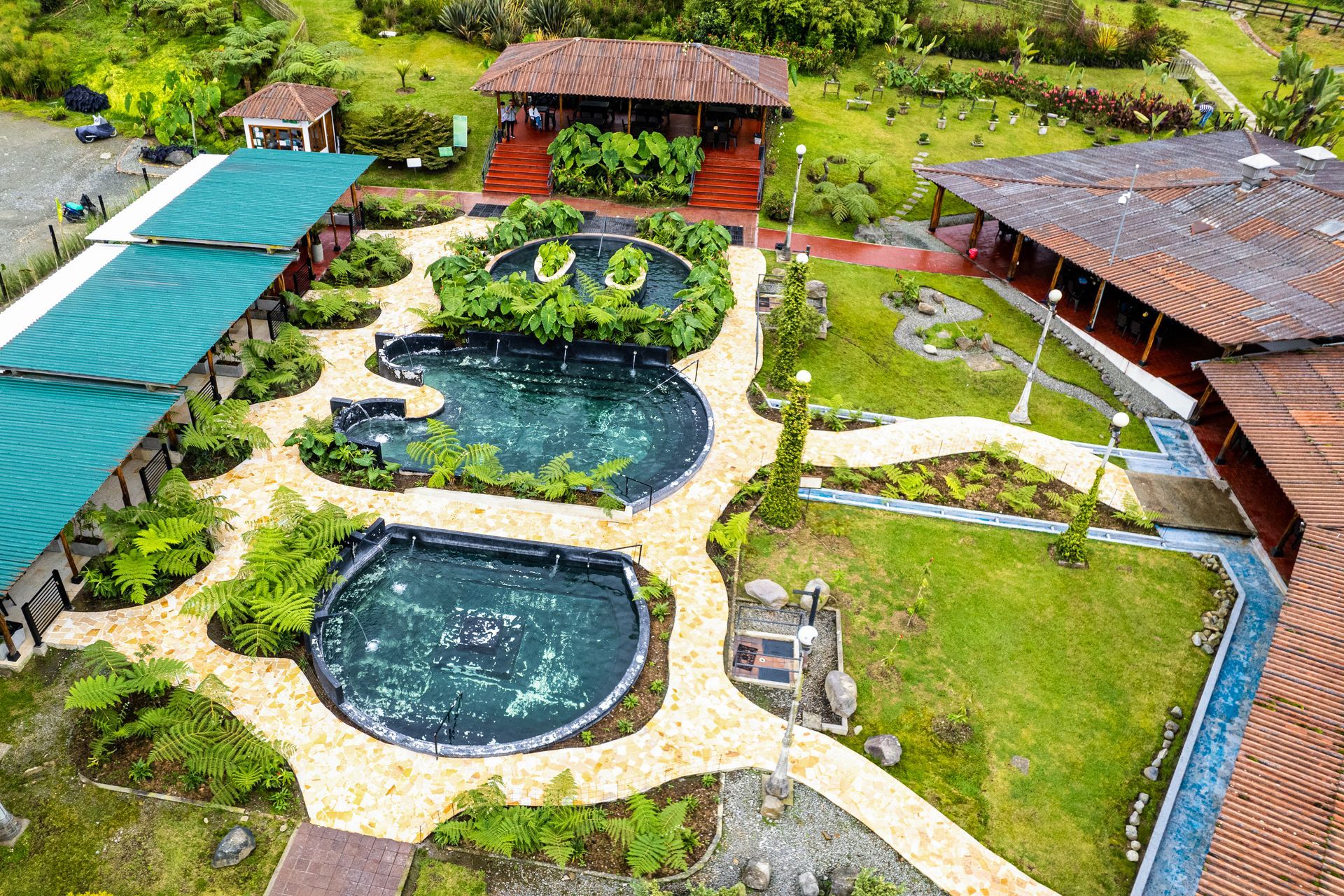 Aerial view of thermal pools and scenic walking trails at Termales El Otoño, a hot springs resort near Manizales.