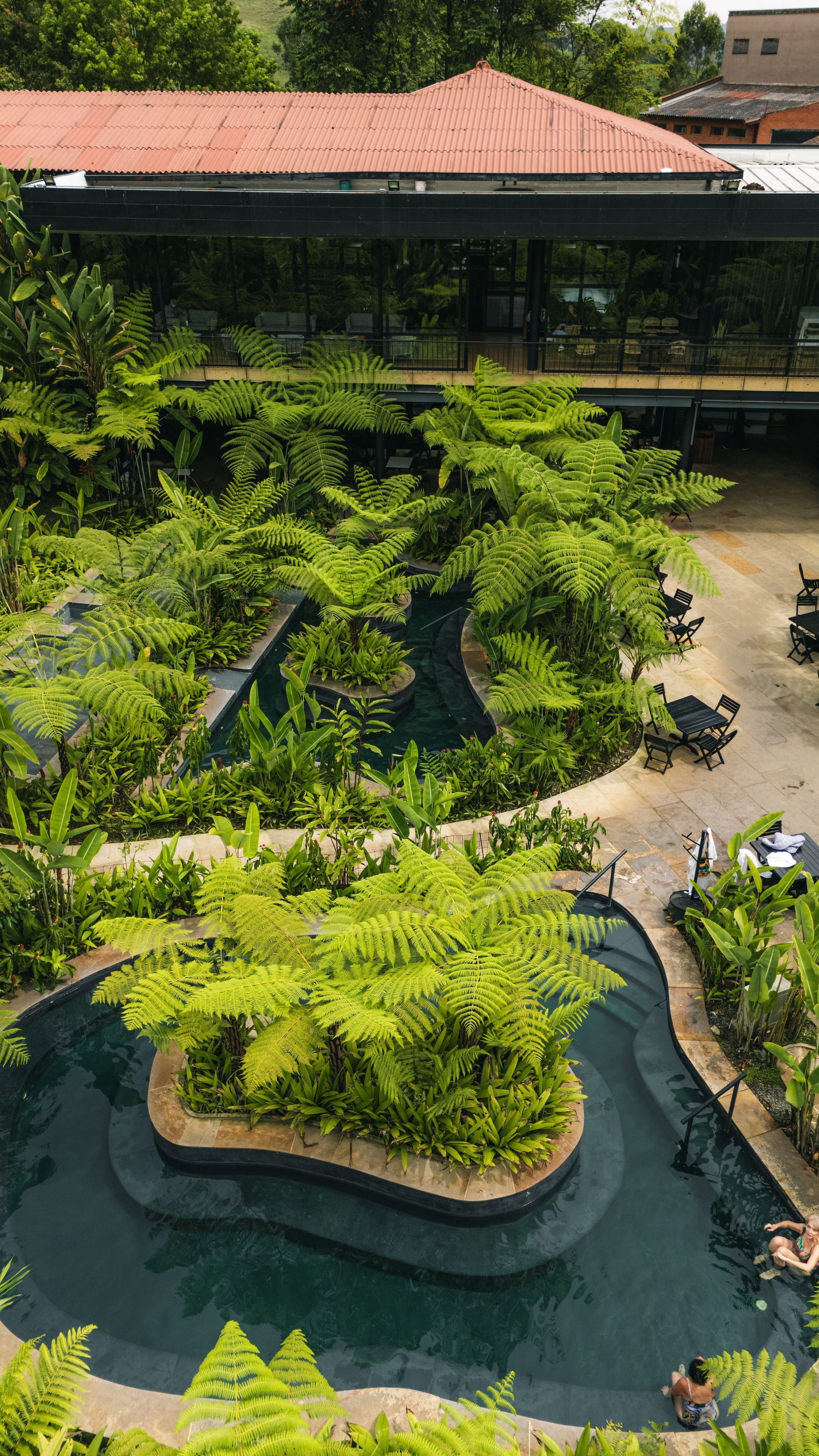 Elevated view of thermal pools, pathways, and relaxation areas at Hotel Termales El Otoño, a hotel near Manizales.
