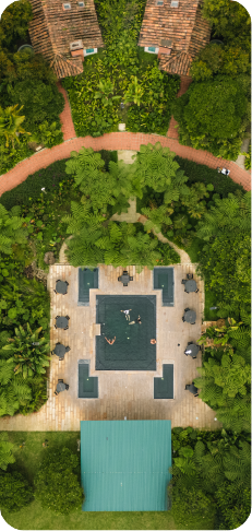 Aerial view of green areas and thermal pools at Hotel Termales El Otoño in Colombia.